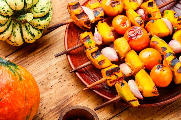 Vegetarian pumpkin and yellow tomato kebabs.Pumpkin fried on skewers.