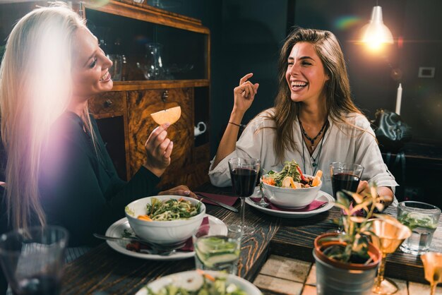 Vegetarian Restaurant Cheerful Female Friends Enjoying Fresh Salad in Restaurant and Having Fun