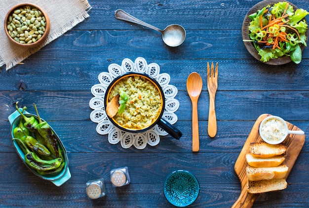 Photo vegetarian risotto with various vegetables, on wooden rustic table,