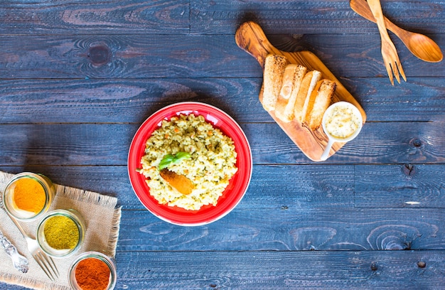 Vegetarian risotto with various vegetables, on wooden rustic table. 