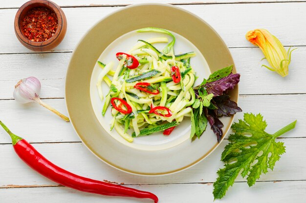 Vegetarian salad with fresh zucchini, peppers and garlic.