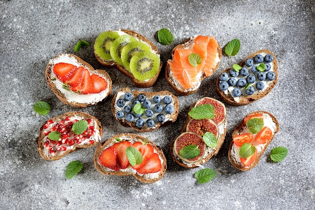 Vegetarian sandwiches from rye bread with soft cheese, and fruits