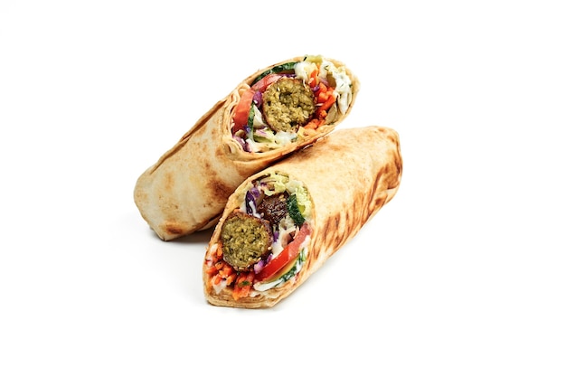 Vegetarian shawarma with falafel vegetables and white sauce isolated on a white background