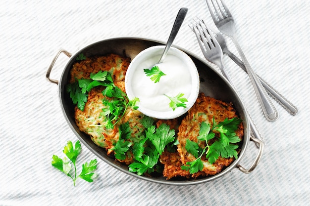 Vegetarian snacks appetizers courgettes fritters pan healthy breakfast white  top view