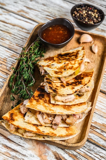 Vegetarian snacks quesadilla with vegetables and cheese  on wooden tray. top view.