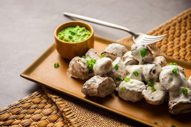 Vegetarian soya malai chap made using soya chaap with white creamy gravy