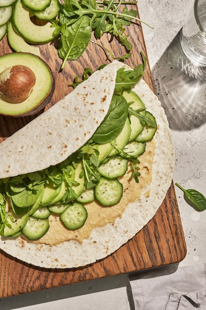 Vegetarian tortilla with hummus and green vegetables