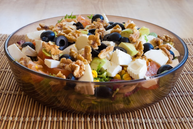 Foto vegetarische en gezonde salade met walnoten, zwarte olijven en kaas