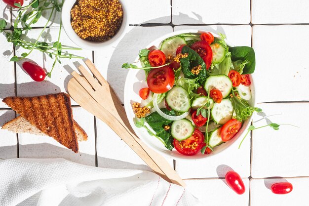 Vegetarische salade met komkommertomaat en spinazie in een bord