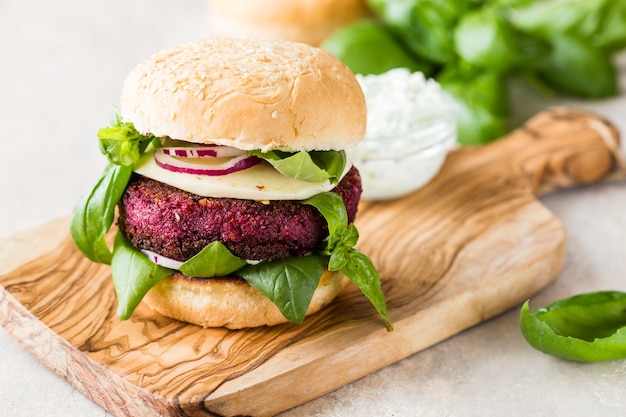 Veggie beet  burgers with vegetables and  greek sauce.