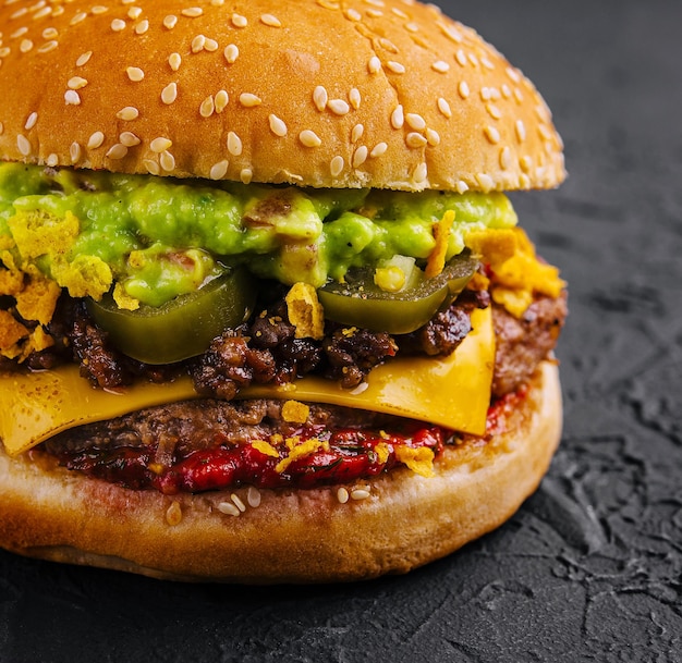 veggie burger with guacamole and pickles on toasted bun