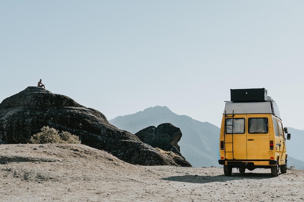 Vehicle parked on mountain against clear sky