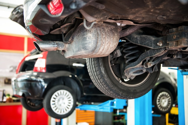 Vehicle in a repair workshop on a lift or hoist