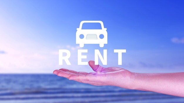 Vehicle transportation investment and car mortgage financial concept Realtors hand puts with icon car and word RENT Rent a car