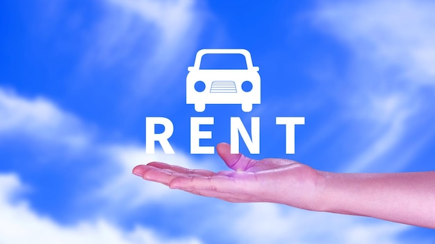 Vehicle transportation investment and car mortgage financial concept Realtors hand puts with icon car and word RENT Rent a car