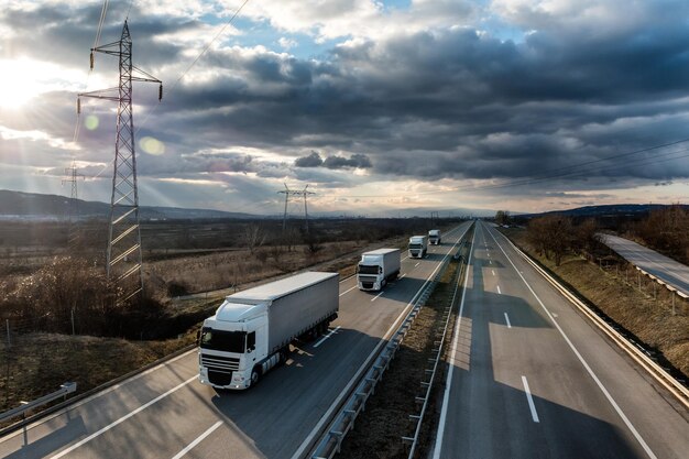 Vehicles on highway against sky