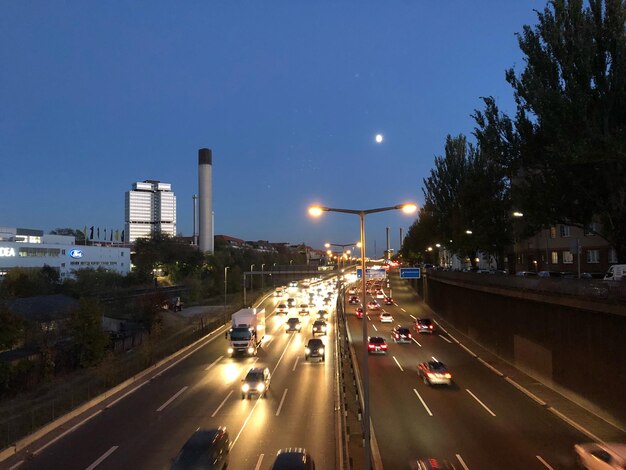 Vehicles on road in city at night