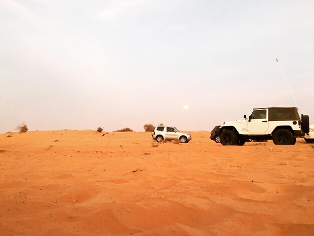 Vehicles on sand at desert