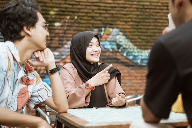 Veiled female students smile while chatting