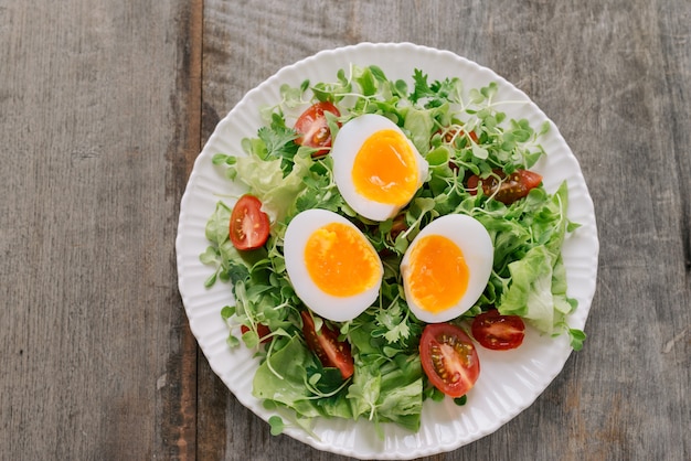 Veldsla salade, hardgekookte eieren, tomaten en honing-mosterddressing