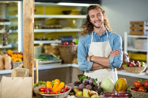 Vendor standing at the counter with arms crossed