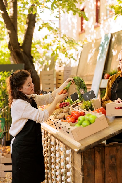 Vendors arranging greenmarket stall