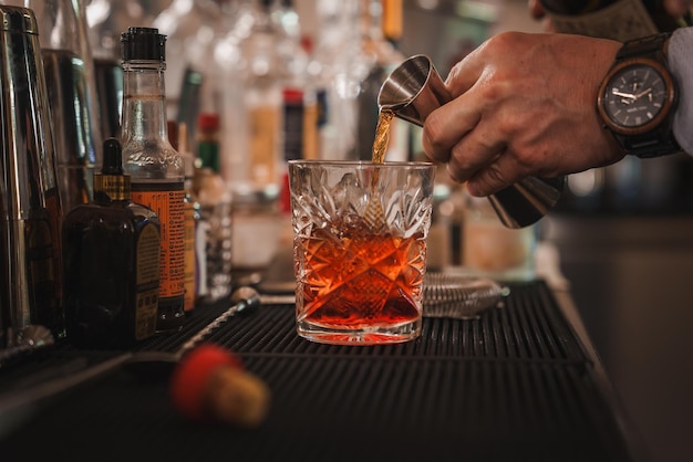 Venetian bartender pouring luxurious alcoholic drink into martini glass in stylish setting