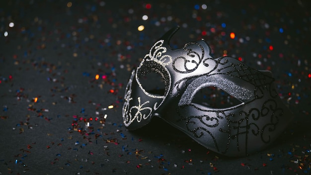 Venetian carnival mask with black glitter background