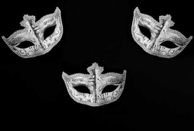 Venetian carnival masks on the black background Top view Closeup