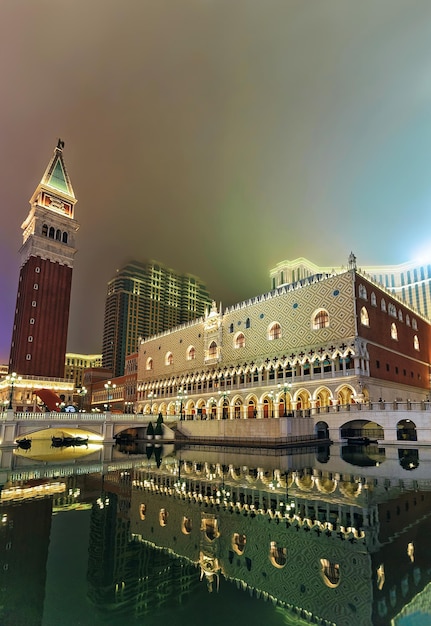 Venetian Macau Casino and luxury resort at Macao, China. Late in the evening. Illuminated with golden light. People on the background