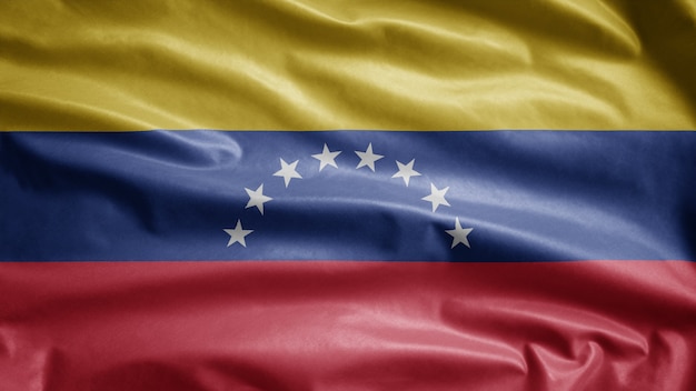 Venezolaanse vlag wappert in de wind. Venezuela sjabloon blazen, zachte en gladde zijde. Doek stof textuur ensign achtergrond.