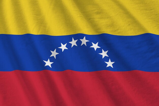 Venezuela flag with big folds waving close up under the studio light indoors the official symbols an