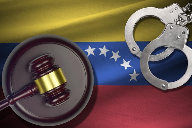 Venezuela flag with judge mallet and handcuffs in dark room Concept of criminal and punishment background for judgement topics