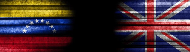 Photo venezuela and united kingdom flags on black background