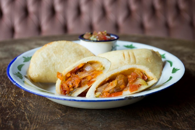 Venezuelan empanadas are made from precooked white or yellow cornmeal.