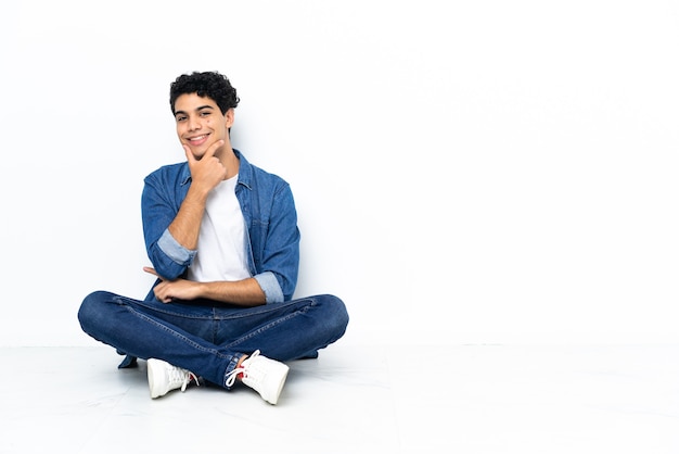 Venezuelan man sitting on the floor smiling