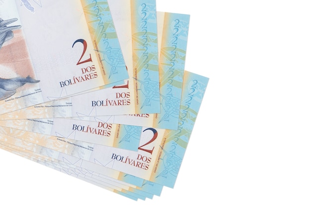 Venezuelian bolivar bills lies in small bunch or pack isolated on white