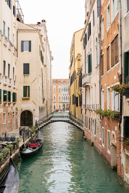 Venice canal between colorful facades and with gondolas