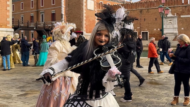 Venice Carnival People in Venetian carnival masks and costumes on streets of Venice Italy Europe February 10 2024