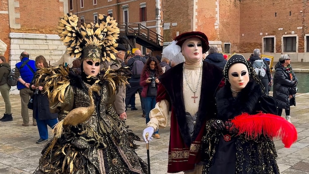 Venice Carnival People in Venetian carnival masks and costumes on streets of Venice Italy Europe February 10 2024