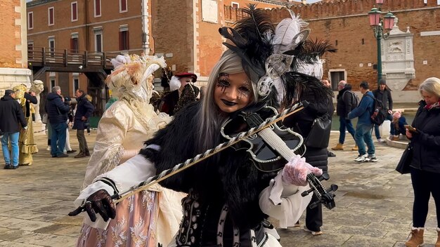 Venice Carnival People in Venetian carnival masks and costumes on streets of Venice Italy Europe February 10 2024