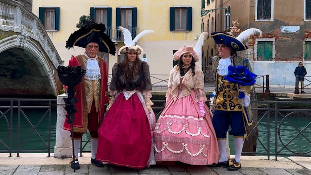 Venice Carnival People in Venetian carnival masks and costumes on streets of Venice Italy Europe