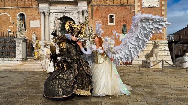 Venice Carnival People in Venetian carnival masks and costumes on streets of Venice Italy Europe