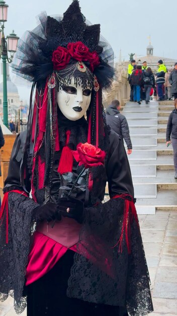 Venice Carnival People in Venetian carnival masks and costumes on streets of Venice Italy Europe