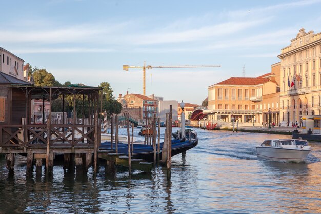 Venice is popular tourist destination of Europe. Beautiful view of Grand Canal with gondolas and colorful facades of old medieval buildings.