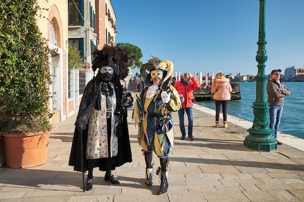 Venice Italy Couple in costumes and masks on the street during the Carnival