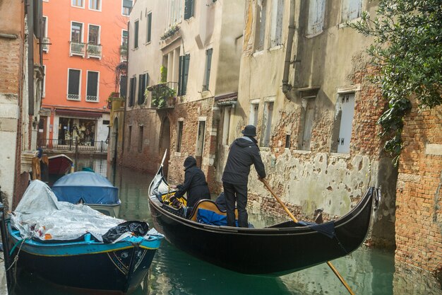 VENICE,ITALY - November 7,2016: View of gondola boat service customer and tourist people in Venice canal and river ,Italy.