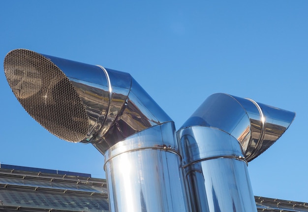 Vent pipes over blue sky