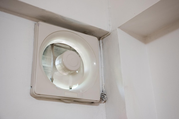 Ventilation fan installed on wall with working in bedroom