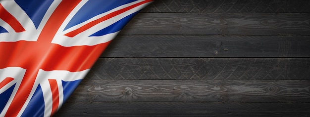 Verenigd Koninkrijk, Britse vlag op zwarte houten muur. Horizontale panoramische banner.
